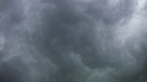 Swirling grey storm clouds moving overhead. Time lapse shot. HD.