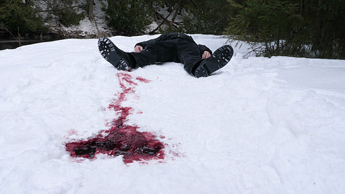 Dead guy lying in the snow with blood trail. Winter murder. Crime scene. HD.