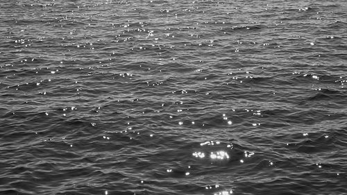 Slow motion lake with sun reflections. B&W. Lake Ontario, Canada. HD stock video.