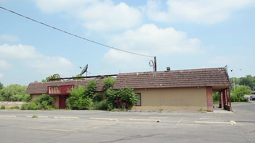 Abandoned restaurant with overgrown parking lot. Welland, Ontario, Canada. HD video.