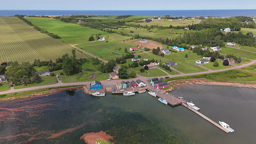 Drone aerial flight tilt down towards community of French River, PEI, Canada. 4K.