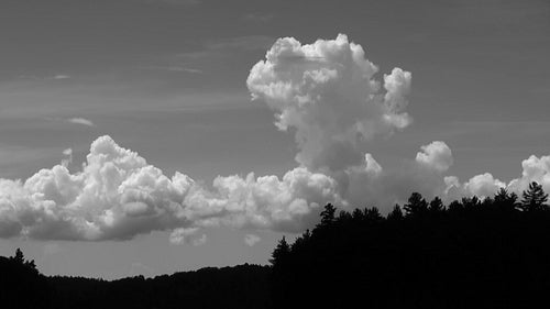 Billowing, rising cumulus clouds. Fast time lapse. Black and white. HDV footage. HD.