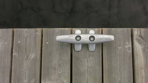 Cleat on wooden deck with water. Top down, horizontal view. HDV footage. HD.