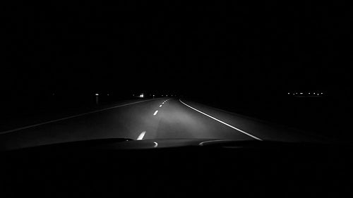 Driving at night on highway corner. Alberta, Canada. Black and white. HD.