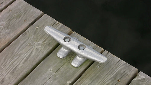 Cleat on wooden deck with water. Closeup, top down, diagonal view. HDV footage. HD.