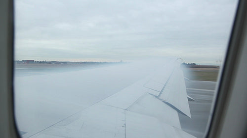 Condensation forming on wing as commercial airliner takes off. HD.