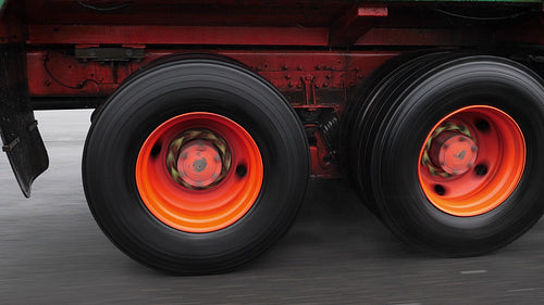 Slow motion shot. Truck wheels spinning on commercial truck in the rain. HD.