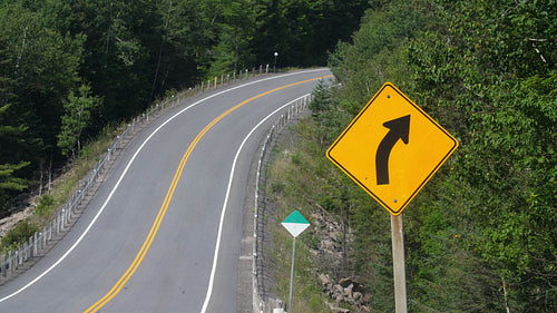 Highway corner with arrow road sign. Summer driving in Ontario, Canada. 4K.