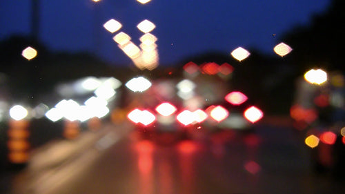 Defocused lights on rainy highway. Busy with emergency vehicle. HDV footage. HD.