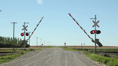 Rail crossing with sound of train coming. Gates lowering. Manitoba. HD.