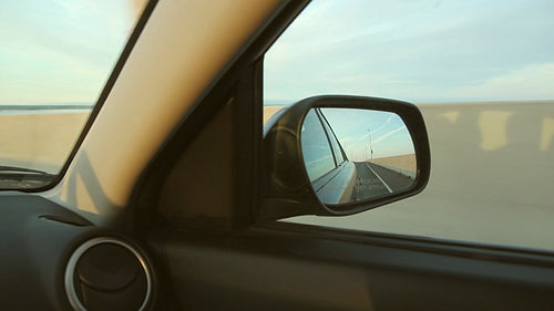 Sunset side mirror. Interior car view. HD.