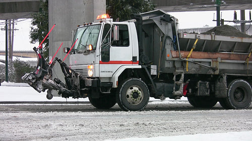 Truck with snow plow blade and sand during snowstorm. Vancouver, BC, Canada. HD video.