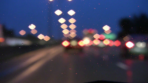 Driving on rainy highway in the evening. Defocused lights. HDV footage. HD.