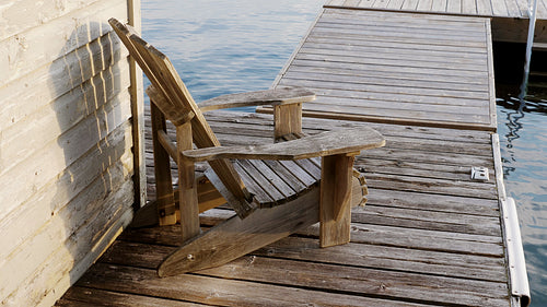 Muskoka chair on wooden dock. Summer in cottage country. 4K.