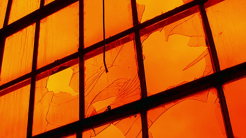 Apocalypse. Sky on fire through broken factory window. Timelapse clouds. HD video.