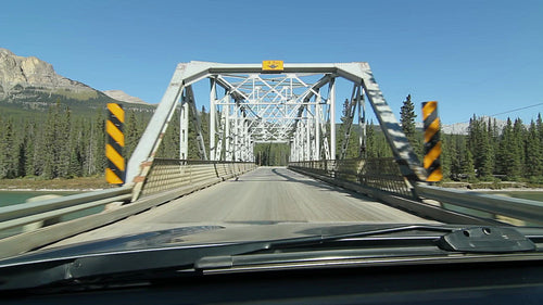 Crossing a truss bridge. POV driving in Alberta, Canada. HD.