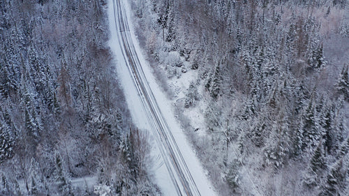 Birds eye view of rural, winter road. Drone aerial. 4K.
