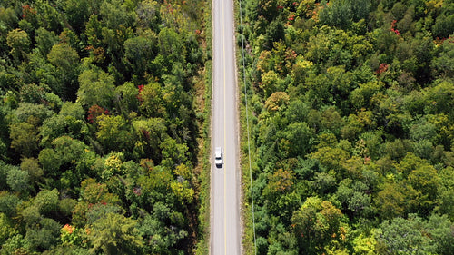 Drone tracking shot of pickup driving on country road. 4K.